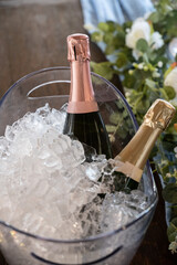 Champagne is chilled and on ice for the bride and groom during wedding reception