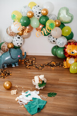 A beautifully decorated party space with green and gold balloons, perfect for birthdays and baby showers.