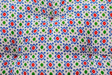 A close-up of a bright and colorful patterned fabric, ideal for textile design and crafts.
