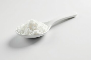 Spoonful of white sugar against white backdrop, kitchen, refined, white