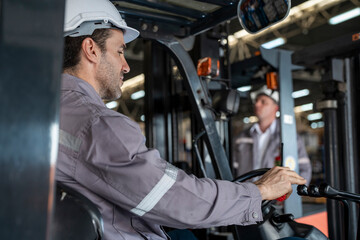 A team of engineers inspects the warehouse in a large storage warehouse. The inspection team uses...