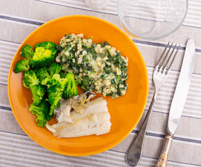 Delicious dish of cod fillet, pearl barley and stewed broccoli
