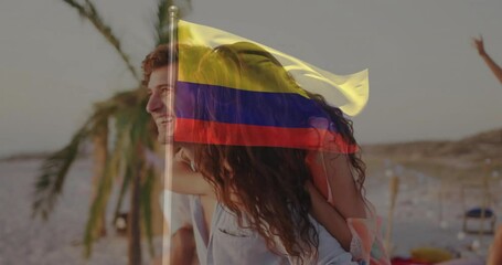 Couple walking on beach with Colombian flag animation overlaying scene - Powered by Adobe