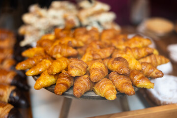 Close-up of showcase, store sells its own baked goods, puff pastry. Croissants, rolls with cheese and chocolate filling
