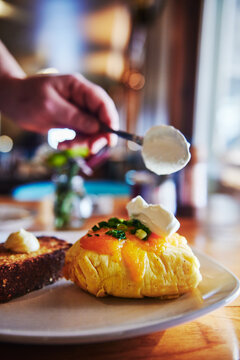 Egg omelette with cheese sour cream and chives and toast with butter