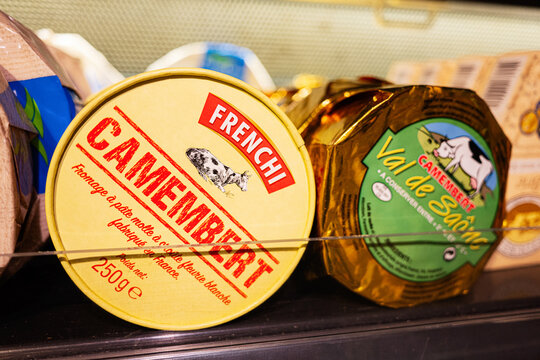 Camembert cheese packaging displayed in a store refrigerator dairy section