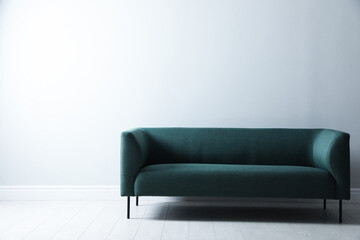 Comfortable green sofa near white wall indoors, space for text. Interior design