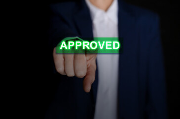 Business woman touching button Approve on virtual screen against black background, closeup