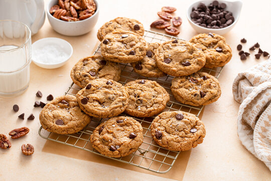 Chocolate chip cookies with pecan nuts, freshly baked cookies on a cooling rack