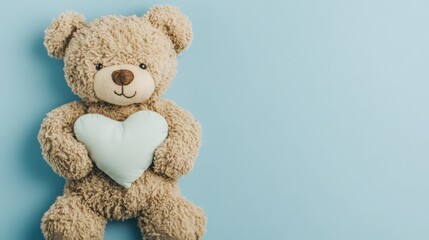 Obraz premium Adorable teddy bear holding a heart on a light blue background.