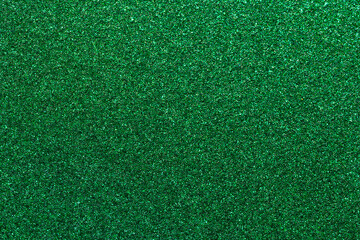 A green field with a lot of grass and a few small patches of dirt