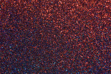 A close up of a red and blue glittery background