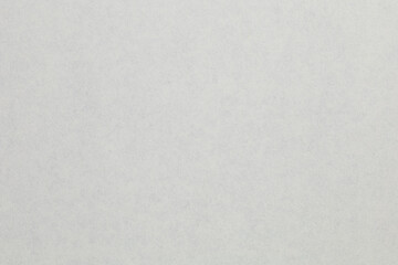 A white background with a few small dots, textured origami paper backdrop