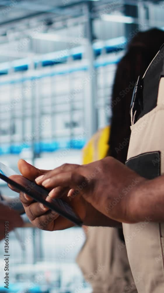 Poster vertical video smart factory expert using digital device app to test automated systems and ensure re