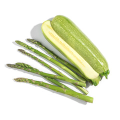 green zucchini cut in half and asparagus, vegetables, on white background, healthy food