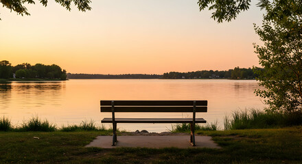 Obraz premium Empty Wooden Bench By Lakeside At Sunset
