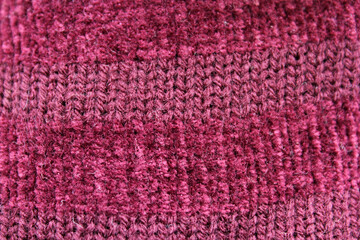 Burgundy maroon knitted wool fabric close-up abstract textured background