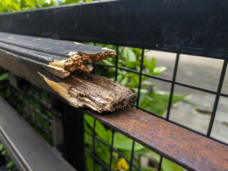 Broken wooden handrail on a walkway in the park, accessibility for park visitors.