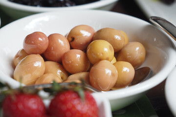 Fresh olives served in a bowl at a vibrant culinary gathering