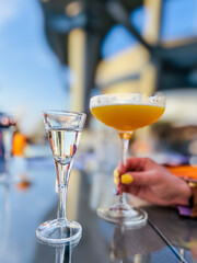 Alcohol cocktail drink French Blonde in a martini glass on the table in the restaurant outdoors.