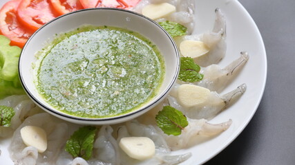 shrimp in fish sauce with Thai spicy seafood dipping sauce on white plate