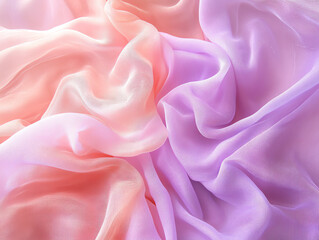 Obraz premium Soft pastel fabric draped elegantly, creating a gentle, flowing texture in shades of pink and purple.