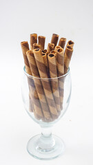 Classic style chocolate wafer rolls with a crispy shell isolated on white background