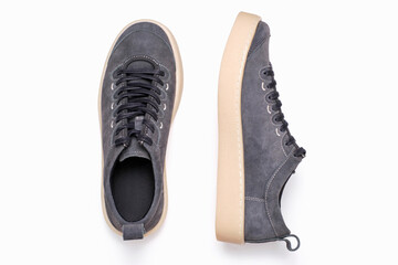 Gray sneakers on white background close-up, top view.