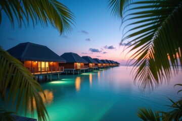 Luxury overwater bungalows in the Maldives at sunset, surrounded by turquoise waters and framed by palm leaves, creating a serene tropical paradise and dream vacation destination