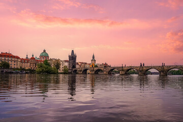 Prague, Czech Republic, at dusk showcases the picturesque Charles Bridge spanning the Vltava River...
