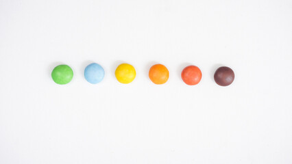 Classic crispy sugar shell chocolate candies with a chocolate filling isolated on white background