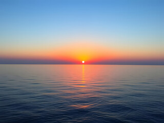 Obraz premium Sunset over calm ocean, vibrant colors, sea horizon, twilight sky, scenic landscape, natural beauty.