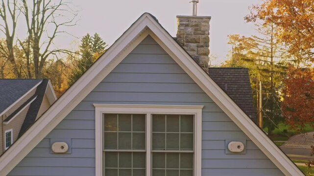 aerial footage showing close up of roof shingles and roof of a single family home.