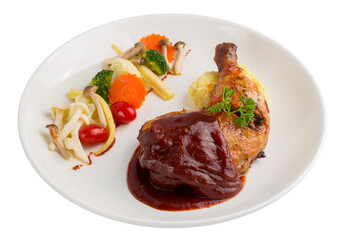 Grilled chicken legs and vegetables in white dish isolated on a transparent background.