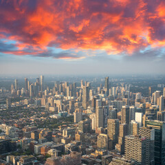Fototapeta premium Aerial view of Toronto skyline from a helicopter at sunset with city lights