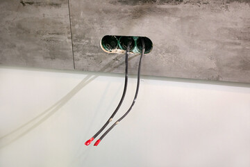  Electrical distribution boxes for electrical outlets are built into the wall with porcelain tiles