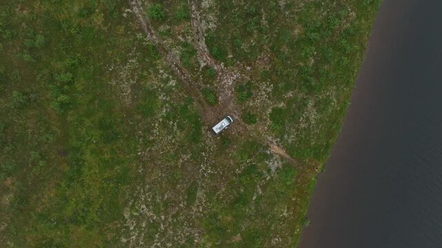 Top view of a van in the vast green landscape of Masi, Kautokeino, Finnmark, Norway