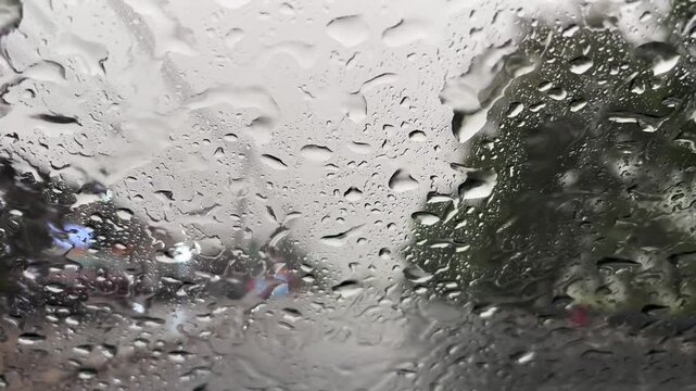View from the windscreen of a moving car when its raining