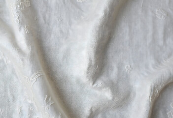 Obraz premium White wrinkled linen fabric with soft folds