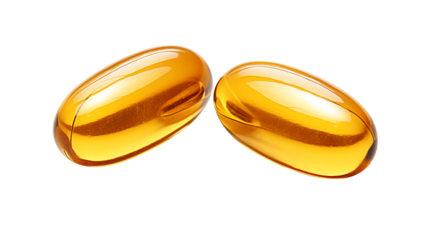 Two golden gel capsules on a black background close up view