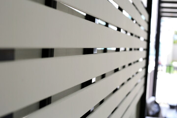 The white slatted fence provides privacy between houses while allowing some airflow and light