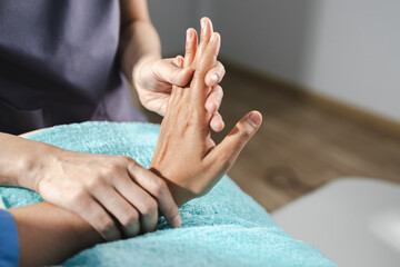 Physical therapy, skilled therapist provides physical therapy by gently massaging hand to promote...