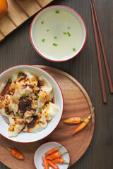 TRADITIONAL FOOD BOILED DUMPLINGS OR PANGSIT REBUS WITH CHILLI OIL