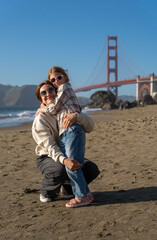 Mother and daughter have fun at the San Francisco beach. 