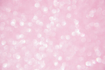 A soft pink bokeh-style background with unfocused light creates an elegant space for text or design elements.