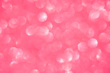 A soft pink bokeh-style background with unfocused light creates an elegant space for text or design elements.