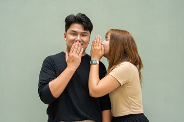 Couple whispering telling secret