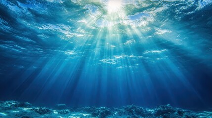 Fototapeta premium Sunlight streams into the deep, blue ocean water from above the surface. Use it for oceanography, marine life, or inspirational, calming backgrounds.