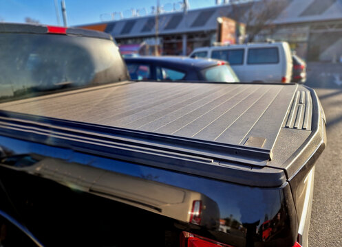 Cover with tail gate locking system designed to fit all standard vehicle security accessory offering a quick and easy way to safely lock away your load.