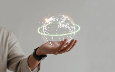 Person's Hand Holding a Holographic Globe Symbolizing Global Connectivity and Future Tech Innovations in a Minimalist Setting, Emphasizing Interconnectedness and Innovation for Global Solutions